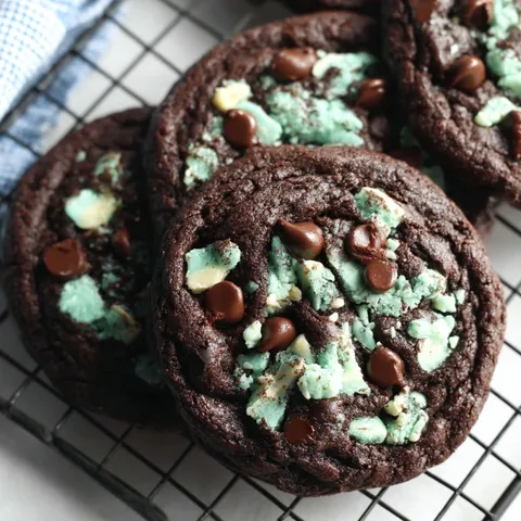 Chocolate mint chip cookies on a cooling rack.