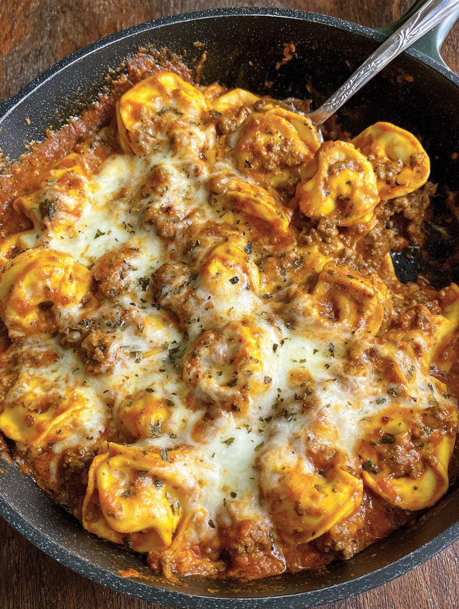 A dish of cheesy ground beef tortellini.