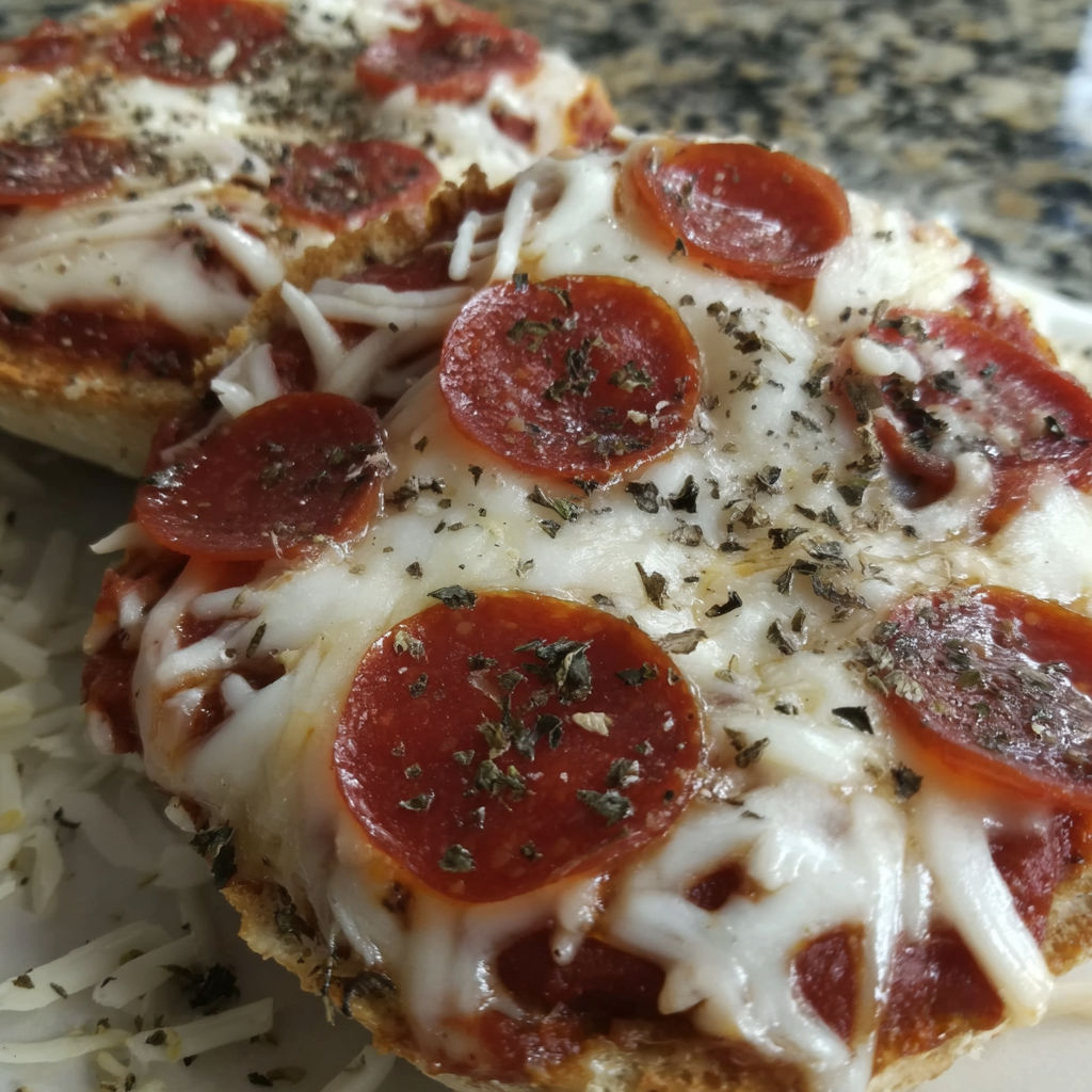 A slice of pizza on an English muffin.
