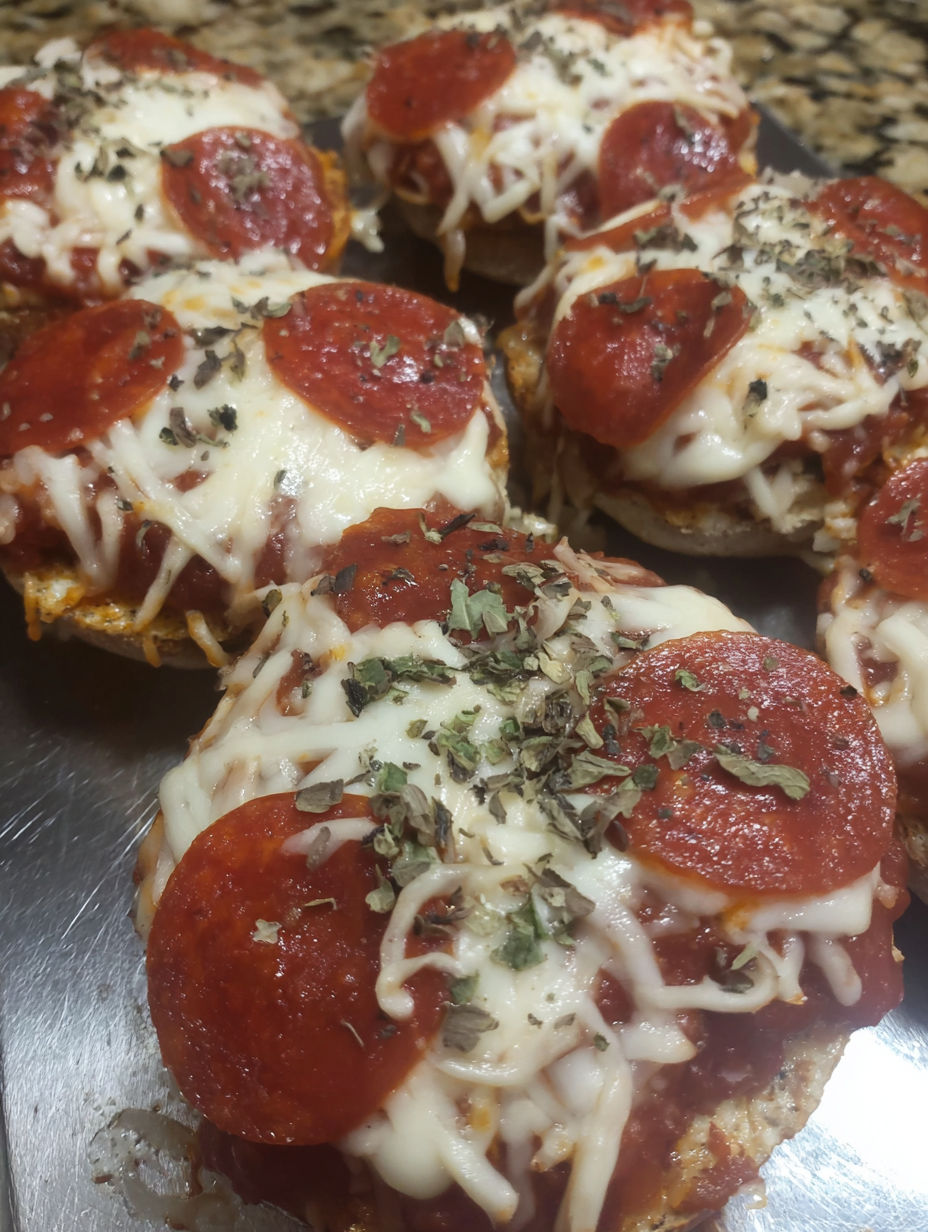 A close up of a pepperoni pizza with cheese and herbs.