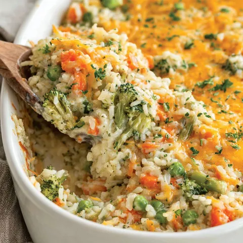 A white bowl filled with a vegetable and rice casserole.