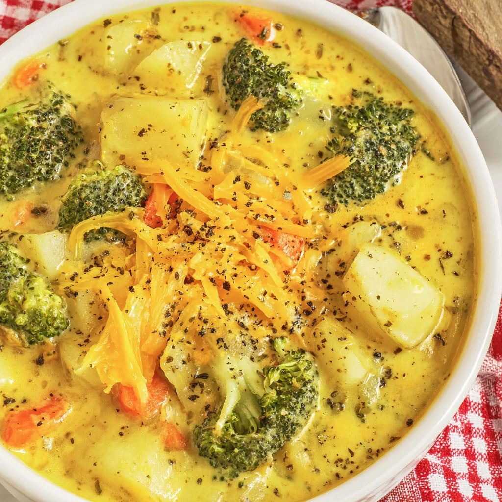 A bowl of soup with broccoli and potatoes.