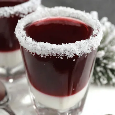 Two Chambord shots with white topping.
