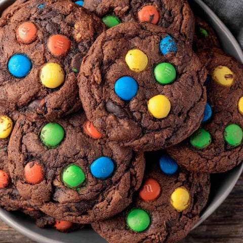 A bowl of chocolate M&M cookies.