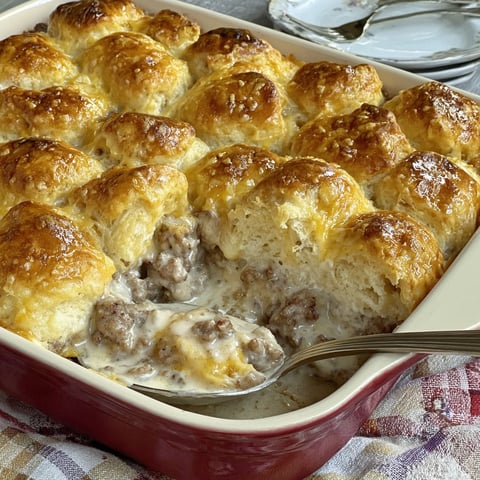 A casserole with biscuits and gravy.
