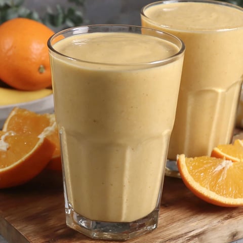 Two glasses of orange creamsicle smoothie.