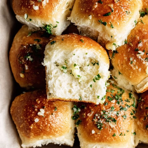A basket of garlic bread rolls.
