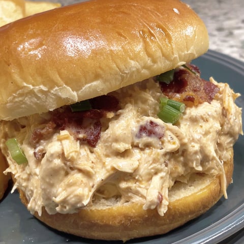 A sandwich with bacon and chicken.