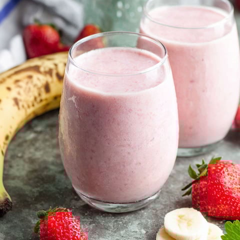 Two glasses of strawberry banana smoothie.