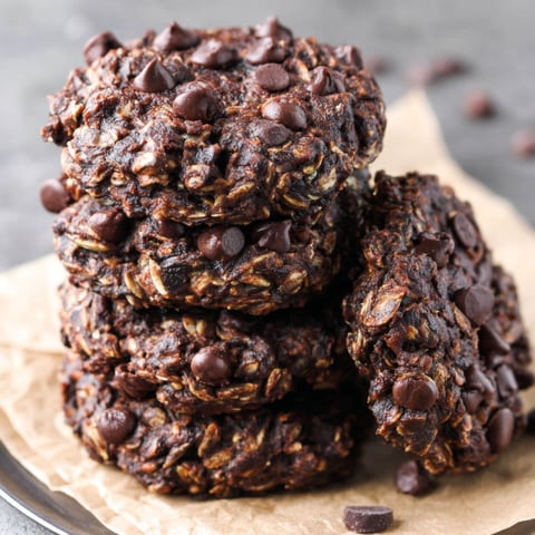 A stack of chocolate chip cookies with chocolate chips on top.