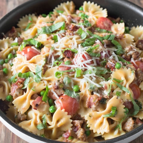 A bowl of pasta with tomatoes and cheese.